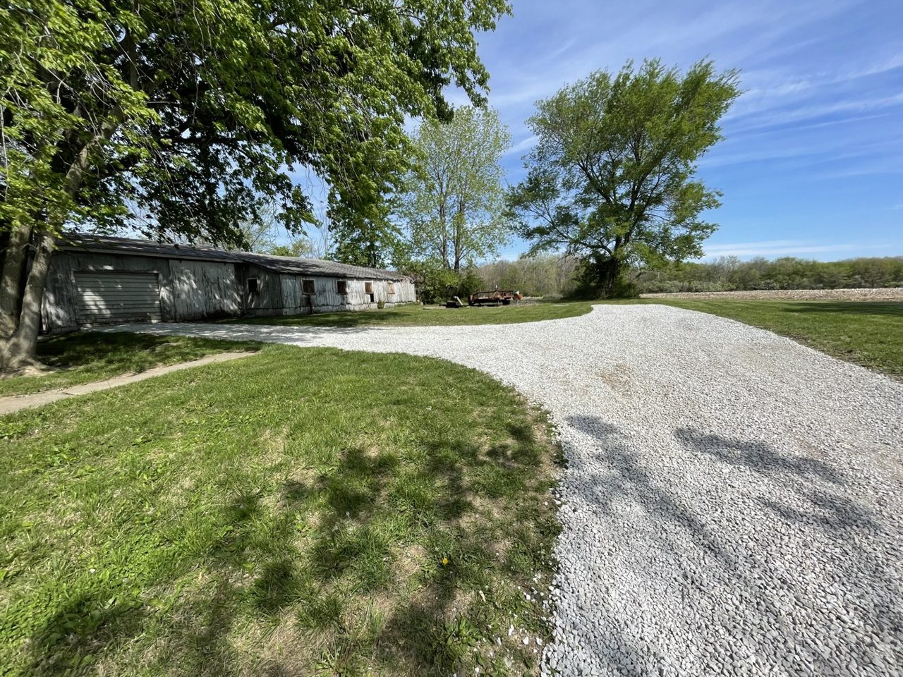 Finished rock driveway curving to a farm building in central Illinois — Brohez Trucking LLC