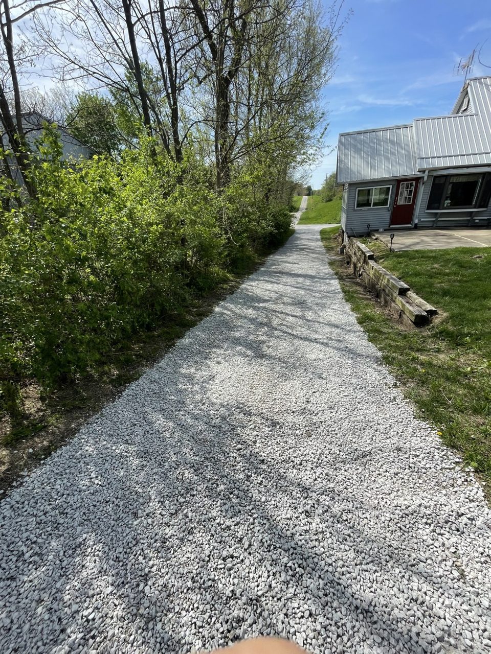 Long tree-lined gravel driveway built to a rural home in central Illinois — Brohez Trucking LLC