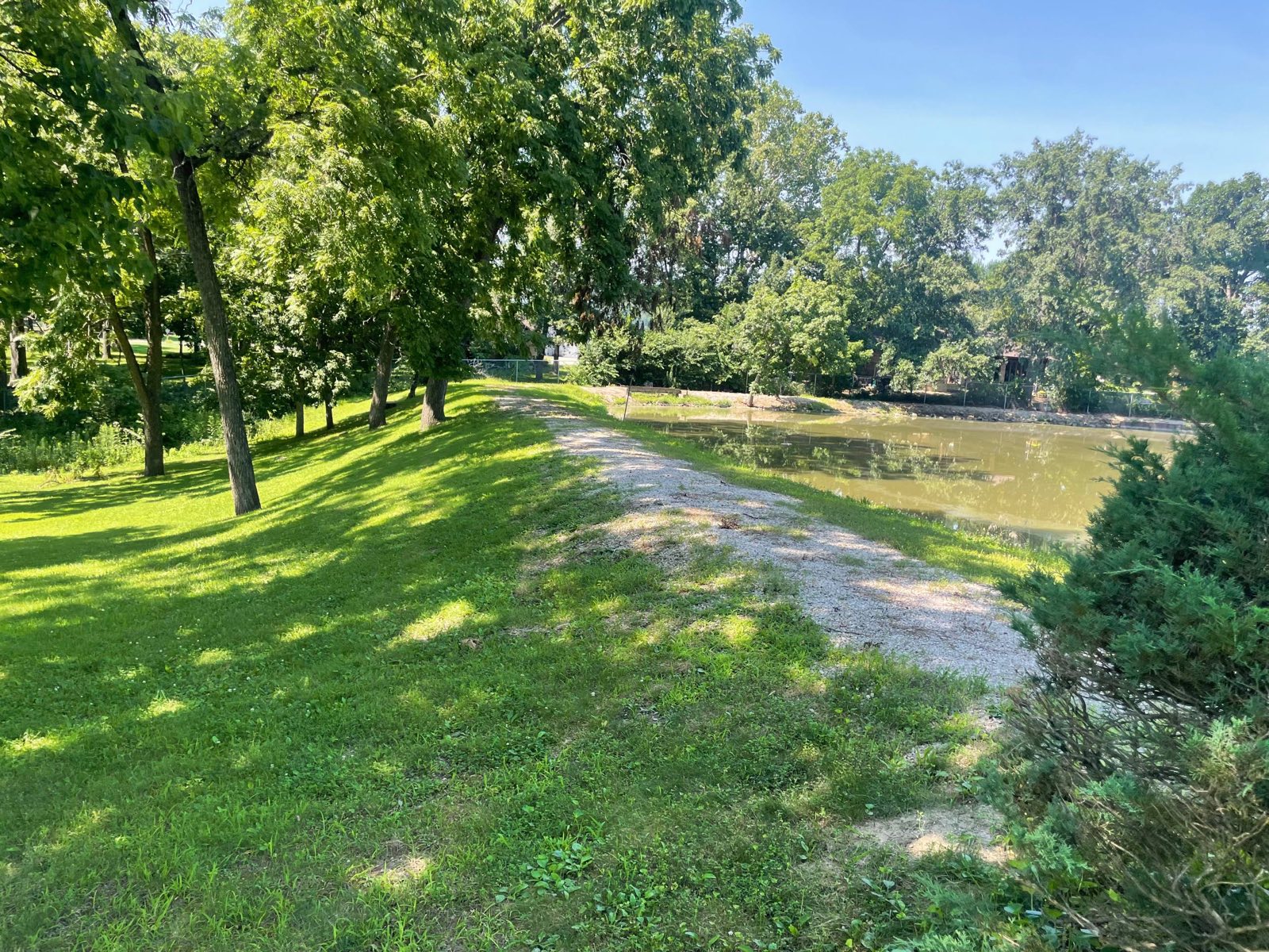 Pond drawn down with a pump so the dam can be worked dry, on a dam repair near Decatur, Illinois — Brohez Trucking LLC