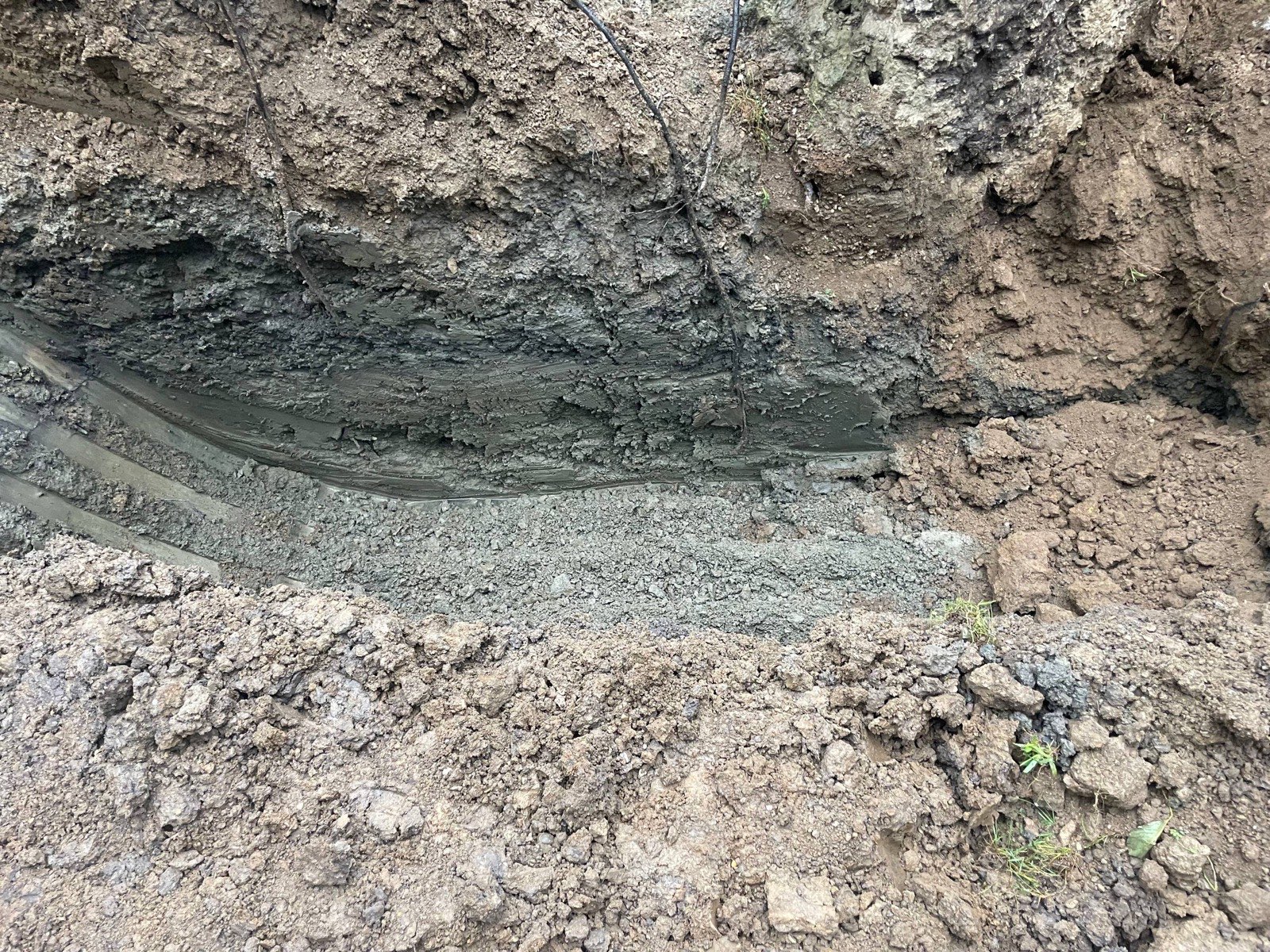 Key trench cut into undisturbed clay through a pond dam during a 40-foot dam rebuild near Decatur, Illinois