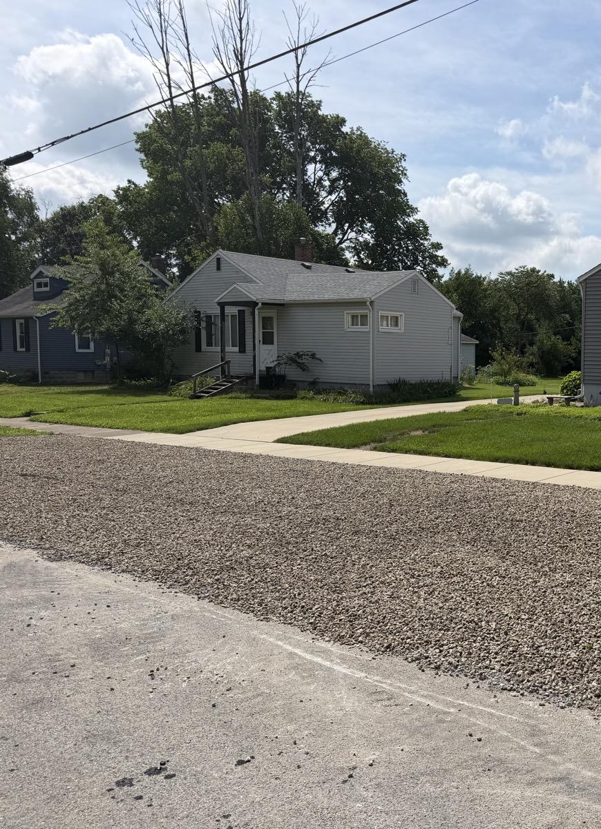 Freshly spread crushed stone on a residential driveway in Tuscola, IL — Brohez Trucking LLC